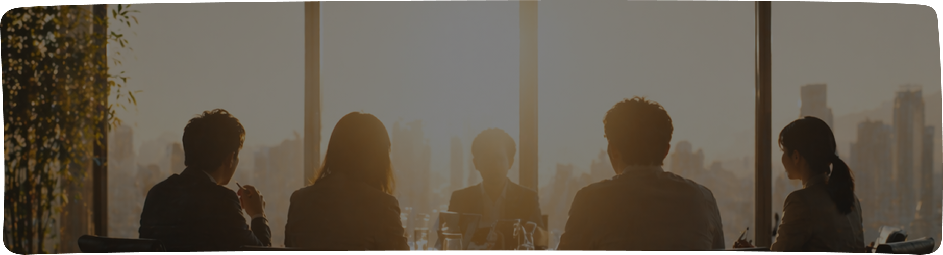 Board members in discussion in a meeting room
