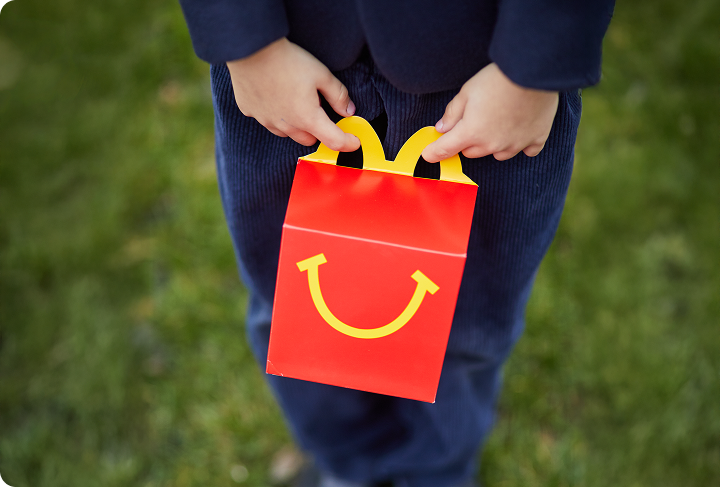 A child holding a Happy Meal box