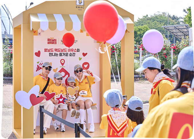 Family taking photos at Ronald McDonald House photo booth