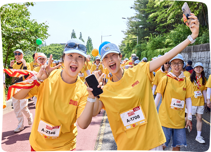 Participants smiling brightly wearing event bibs